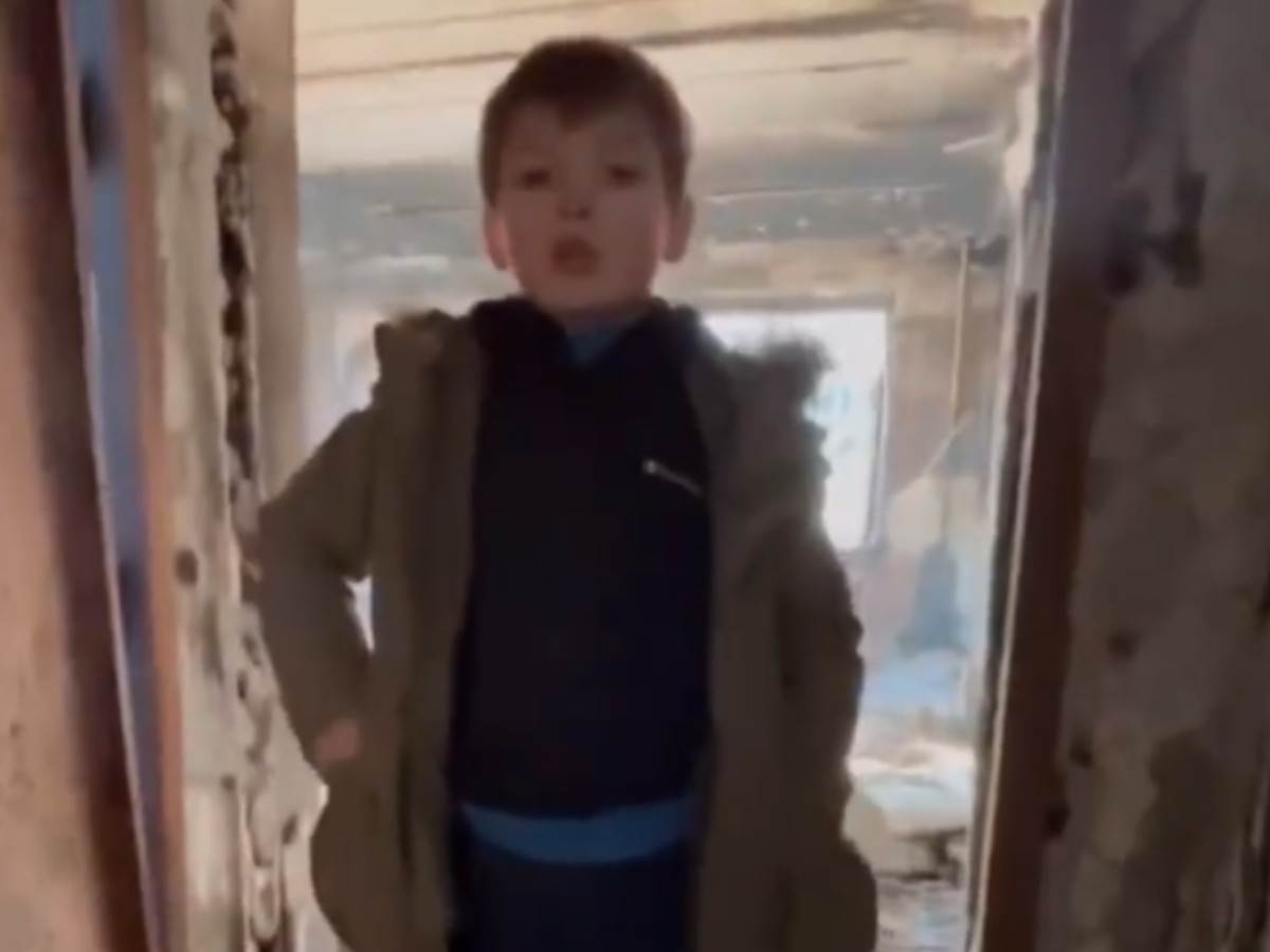  djecak u ukrajini pokazuje srusenu kucu 
