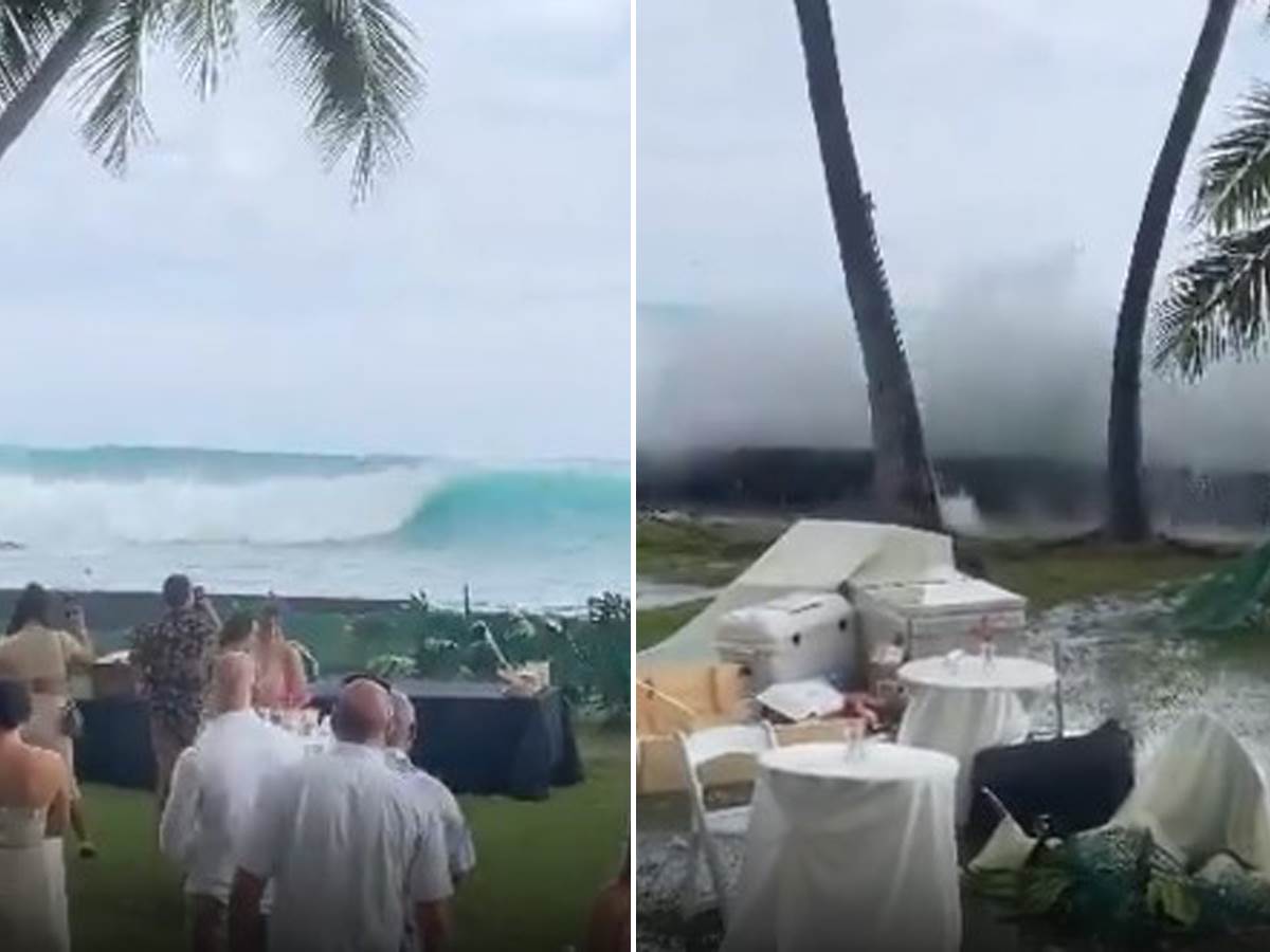  Na snimku sa venčanja na plaži vide se ljudi koji posmatraju kako džinovski talas 